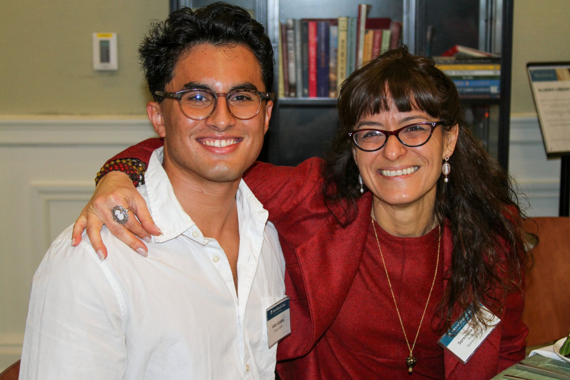 A scholar with UNC Faculty member smiling.